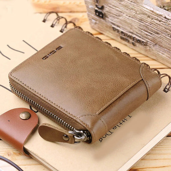 Brown leather wallet with zipper on a wooden surface